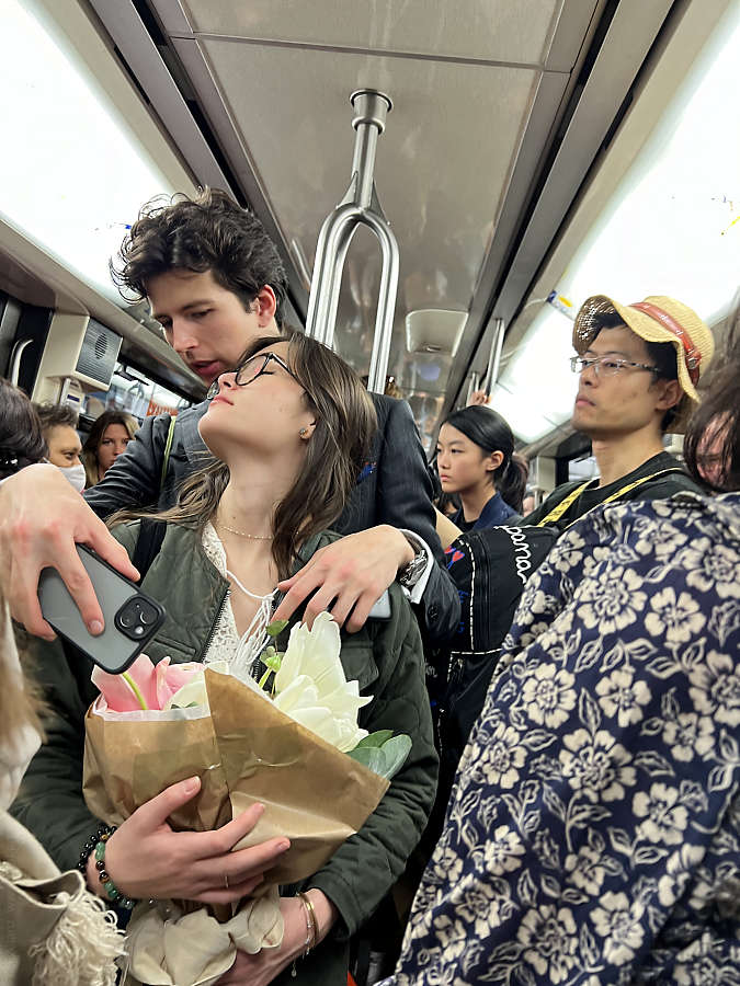 Young woman abandoning herself in the arms of her boyfriend in the Paris metro