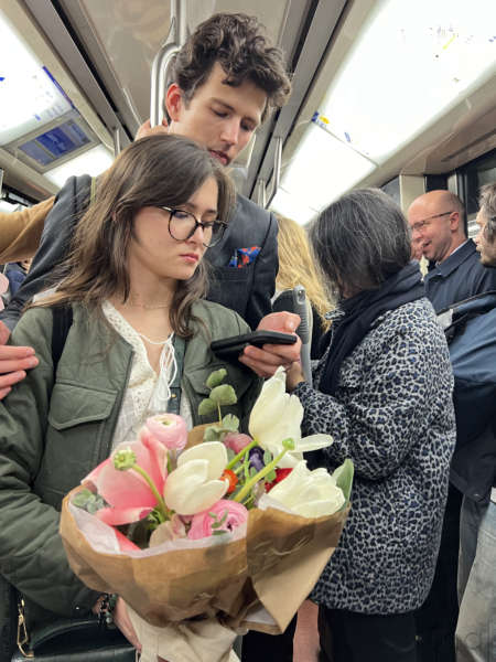 Young couple holding a bouquet of flowers in the Paris metro