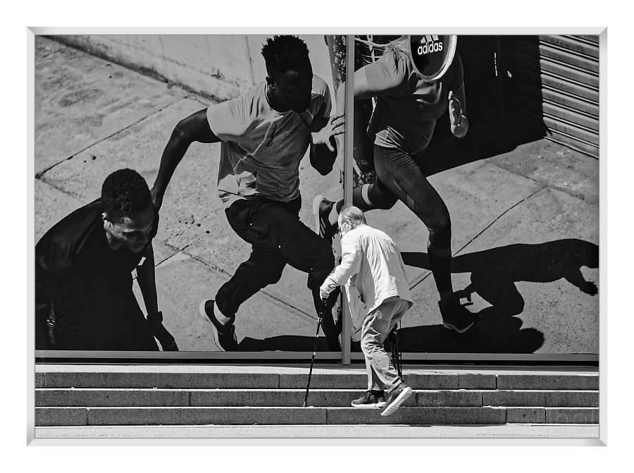 Elderly man climbing stairs at Paris La Défense